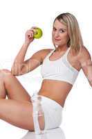 Fitness series - Blond woman in white outfit holding apple