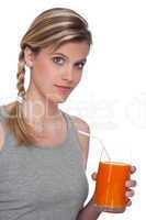 Healthy lifestyle series - Woman holding glass of carrot juice