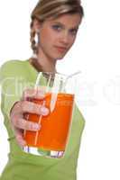 Healthy lifestyle series - Woman holding glass of carrot juice