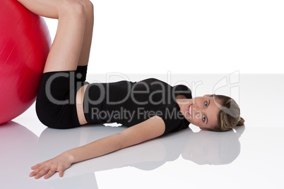 Fitness - Young woman with exercise ball on white