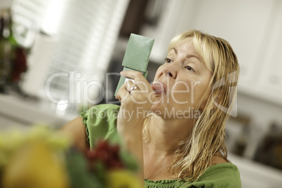 .Woman Sticking Her Tongue Out at Herself in a Mirror