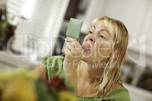 .Woman Sticking Her Tongue Out at Herself in a Mirror