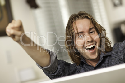 Happy Young Man Using Laptop Computer