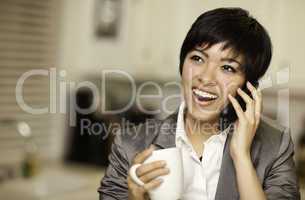 Pretty Multiethnic Woman with Coffee and Cell Phone