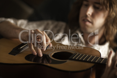 Young Musician Plays His Acoustic Guitar