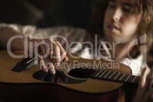 Young Musician Plays His Acoustic Guitar