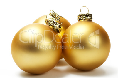 drei matte goldene christbaumkugeln