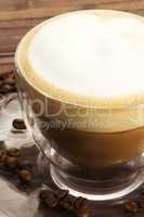 cappuccino auf teller mit kaffeebohnen