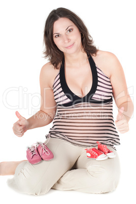 Portrait of pretty pregnant woman baby shoes