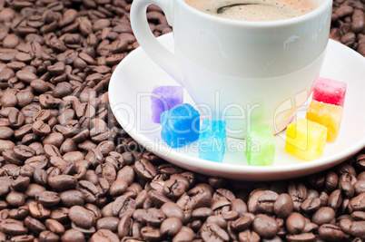 Multicolored slabs of shugar and cup of coffee