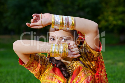 A young Indian woman hiding face