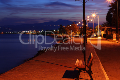 Bench at night time looking out at sea