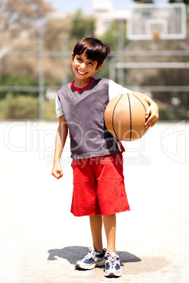 Adorable boy with basketball