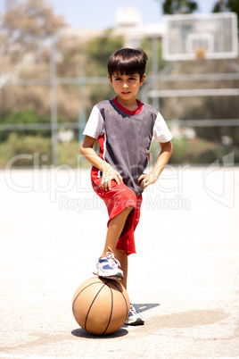 Smart kid holding basketball under his leg