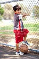 Smart kid posing with basketball
