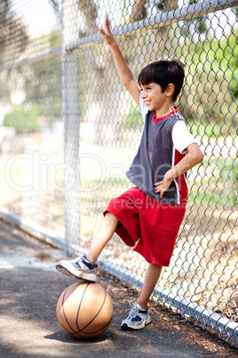Smiling young boy with his basketball