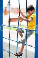 Young boy on playstructure