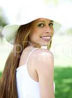 Happy young woman in hat looking away