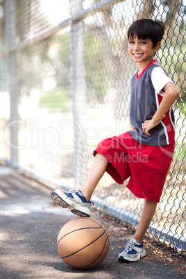 Cute junior boy with basketball