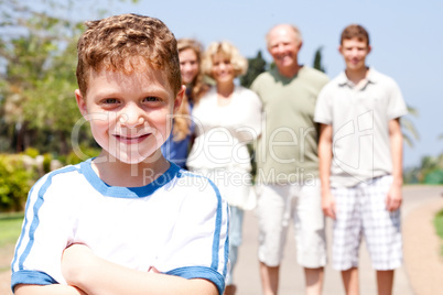 cute boy in focus with family in the background