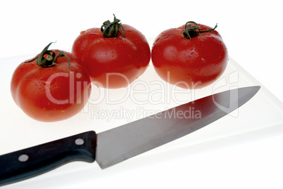 Cutting board with a knife and tomato