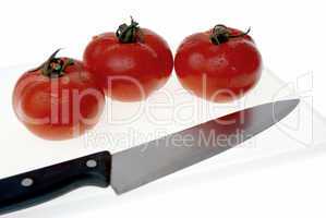 Cutting board with a knife and tomato