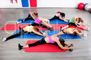 female stretching in an aerobics exercise class