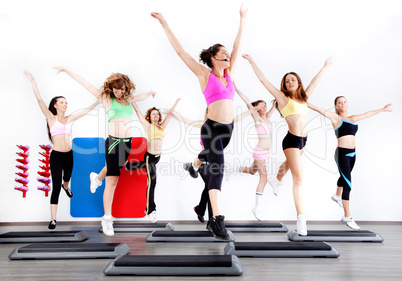 group of women doing aerobics on stepper