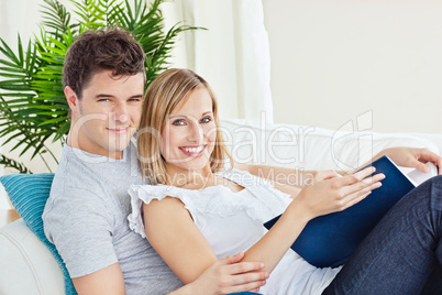 loving couple reading a book on the sofa