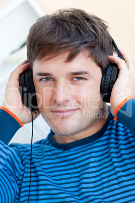 man listening music using headphones