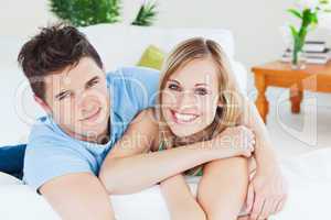 Smiling beatiful couple sitting on a sofa