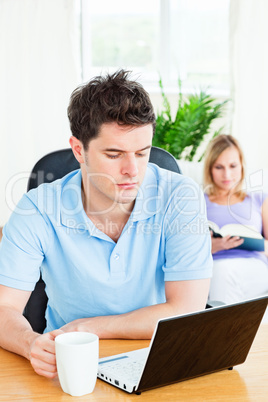 man working on his laptop with his girlfriend