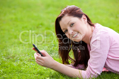 young woman lying on the grass
