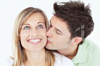 man kissing his smiling girlfriend