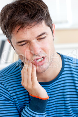 man having a raging toothache