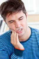 man having a raging toothache