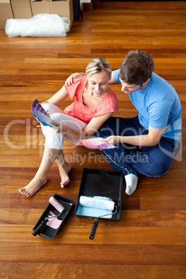 couple sits on the floor picking colors