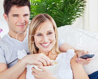 Young couple having fun in front of the TV