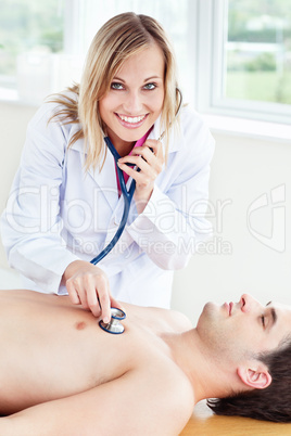 female doctor using stethoscope on a patient