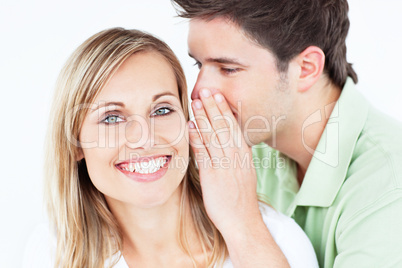 man whispering something to his girlfriend