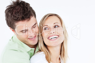 man hugging his laughing girlfriend