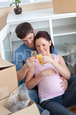 cheerful couple celebrating pregnancy