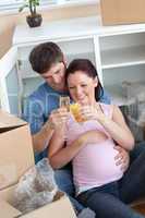 cheerful couple celebrating pregnancy