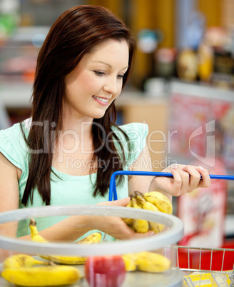 woman buying bananas and apples