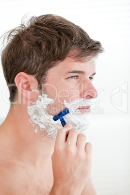 man shaving looking away