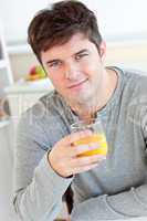 man drinking orange juice