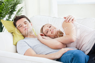peaceful couple resting lying on the sofa