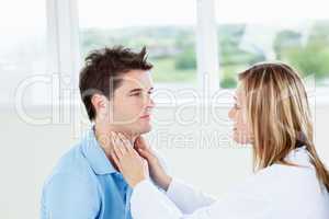 Female doctor examinating her male patient