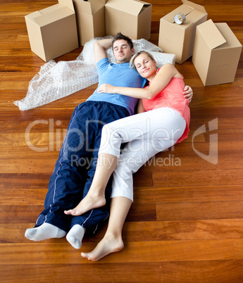 Couple lying on floor with boxes