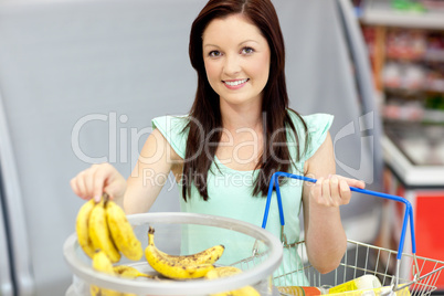 woman with shopping-basket buying bananas